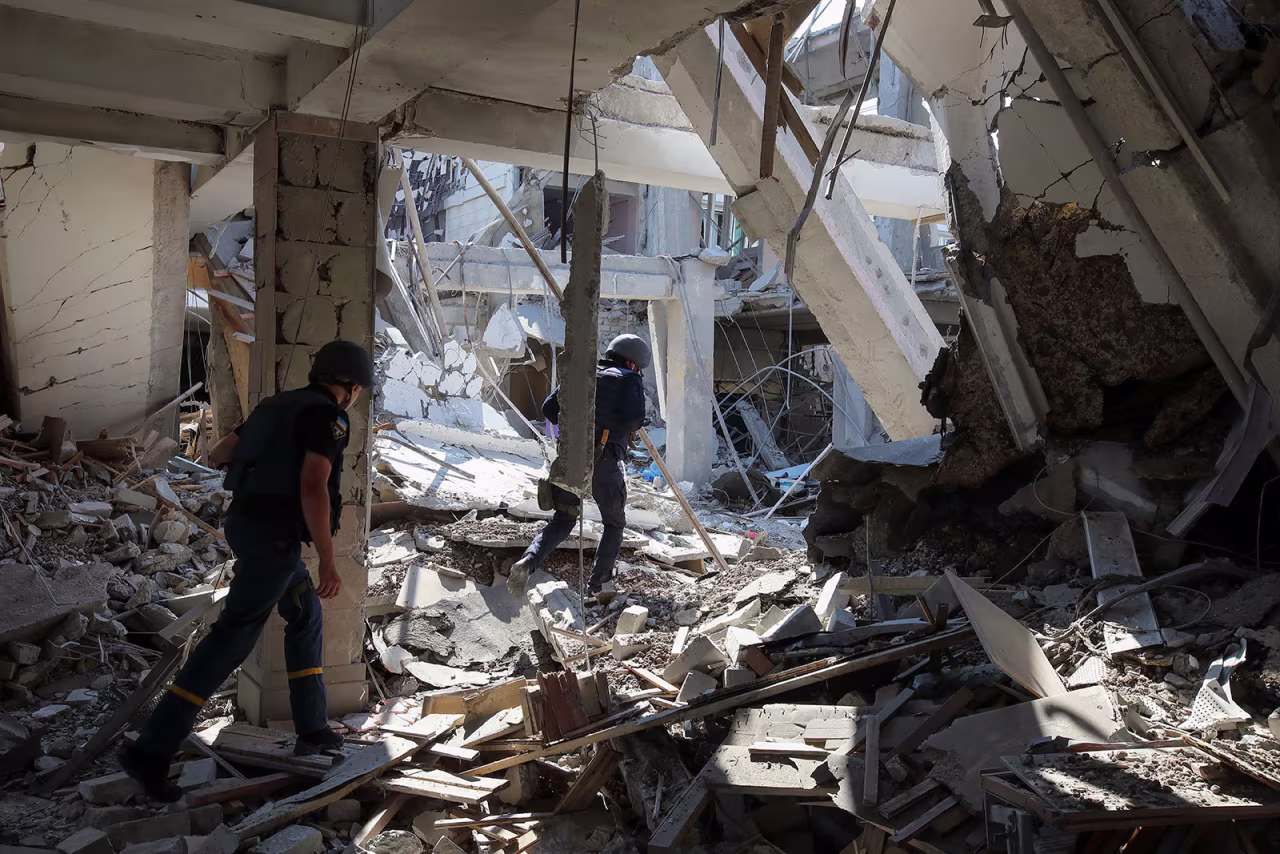 State Emergency Service workers inspect a building at H.S. Skovoroda Kharkiv National Pedagogical University damaged by a Russian missile strike on July 6.