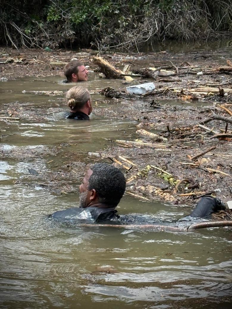 Divers search through debris.