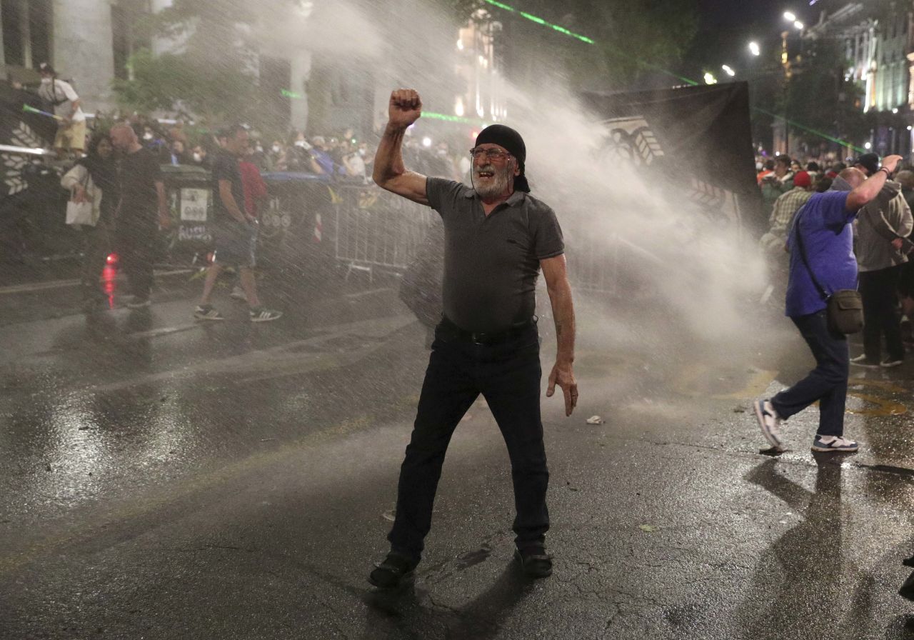 Law enforcement officers use water cannons to disperse protesters in Tbilisi on May 1.