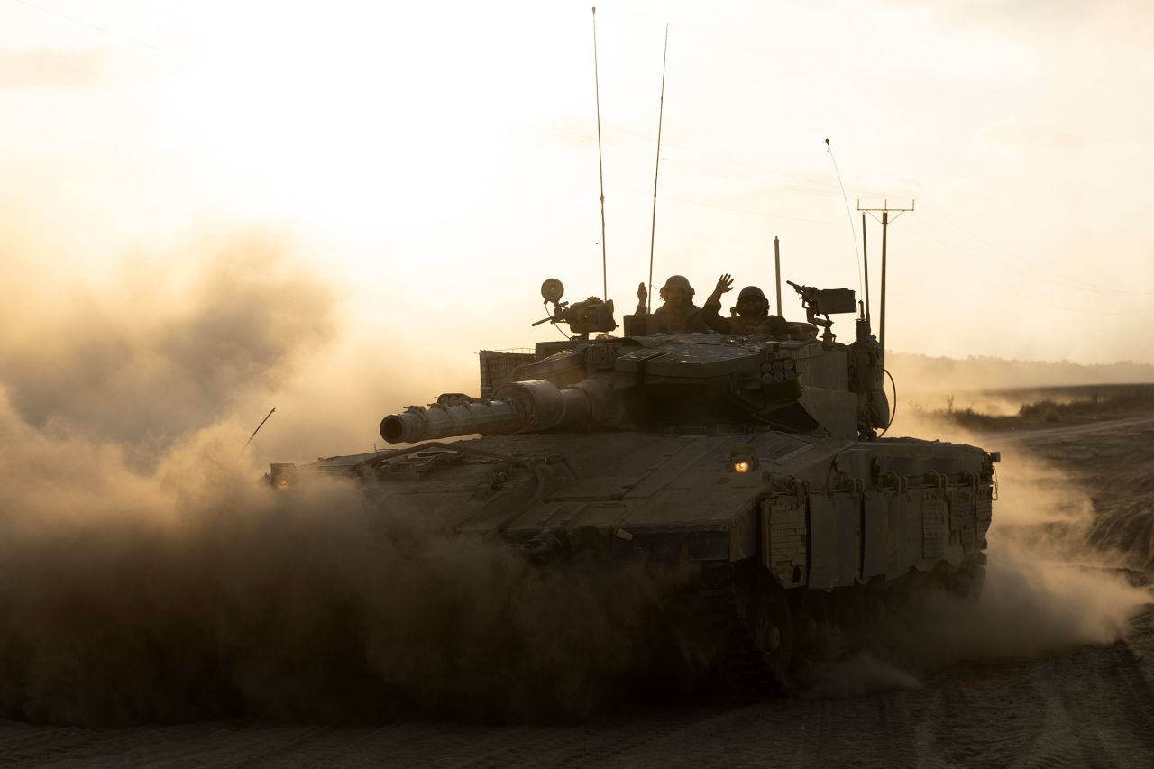 Israeli soldiers in a tank as it drives along the border with the Gaza Strip on August 7 in Southern Israel, Israel.