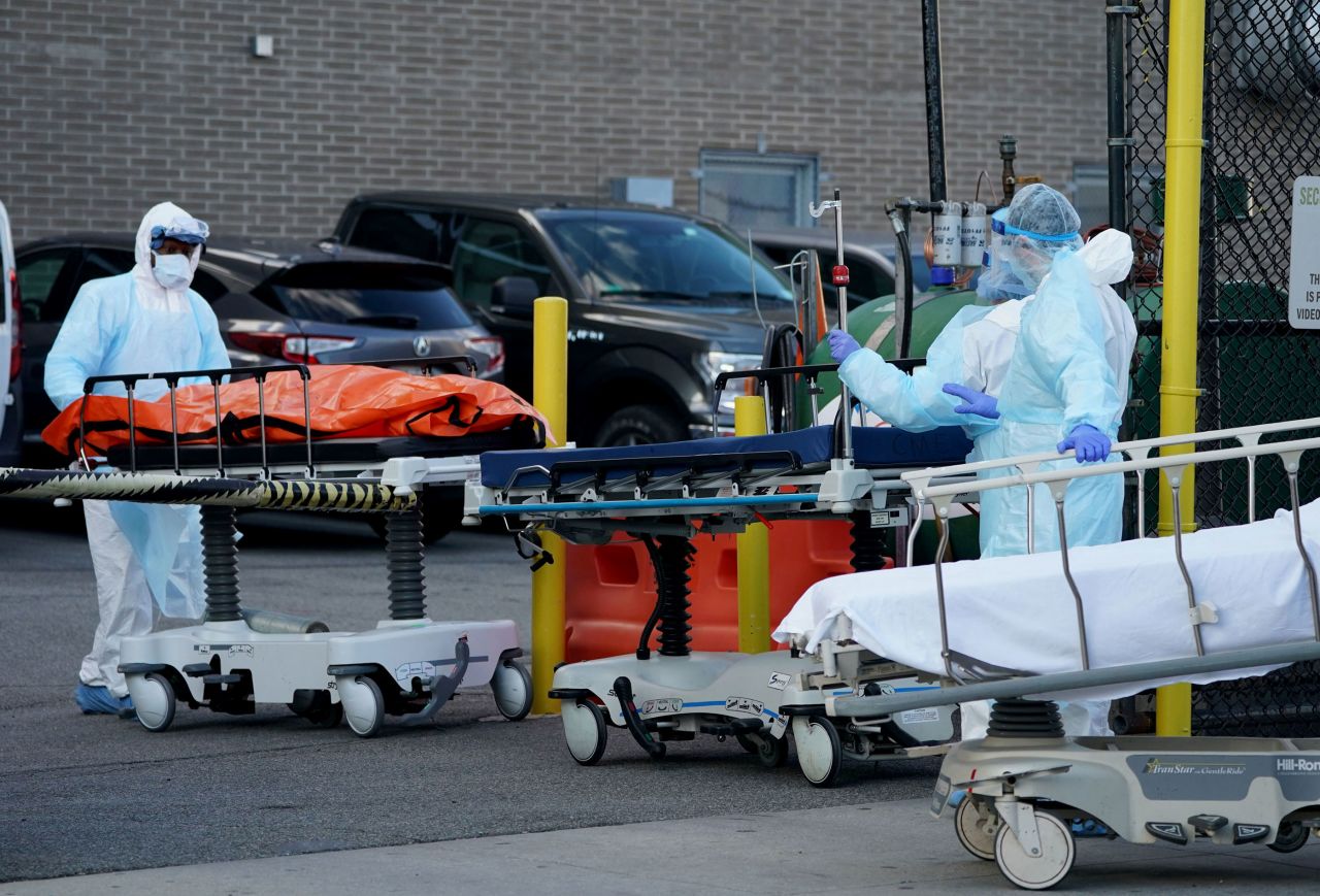 Bodies are moved to a refrigerator truck serving as a temporary morgue outside of Wyckoff Hospital in Brooklyn, New York on April 4.