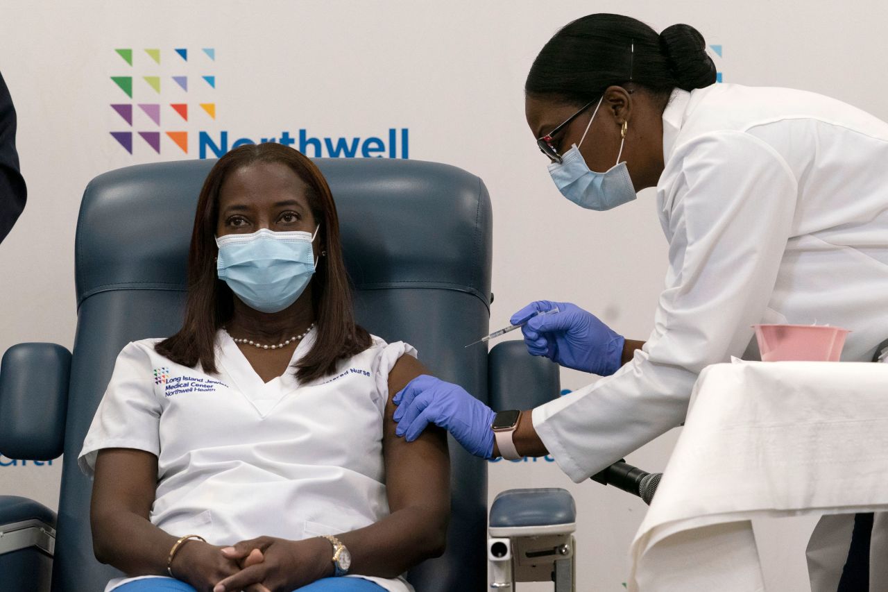 Sandra Lindsay, a nurse at Long Island Jewish Medical Center, is inoculated with the Pfizer-BioNTech Covid-19 vaccine by Dr. Michelle Chester on December 14 in Queens, New York.