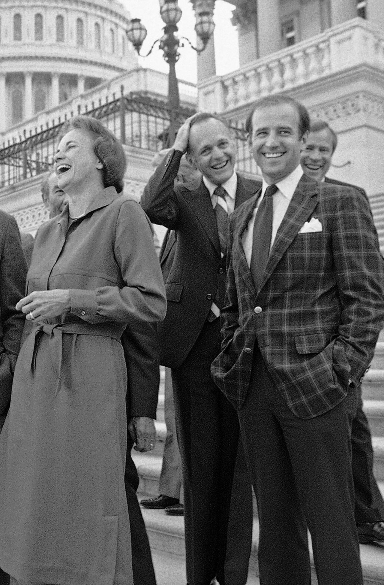 In this September 1981 photo, Sandra Day O'Connor laughs as she stands alongside Sen. Joe Biden just following her confirmation on Capitol Hill in Washington, DC.