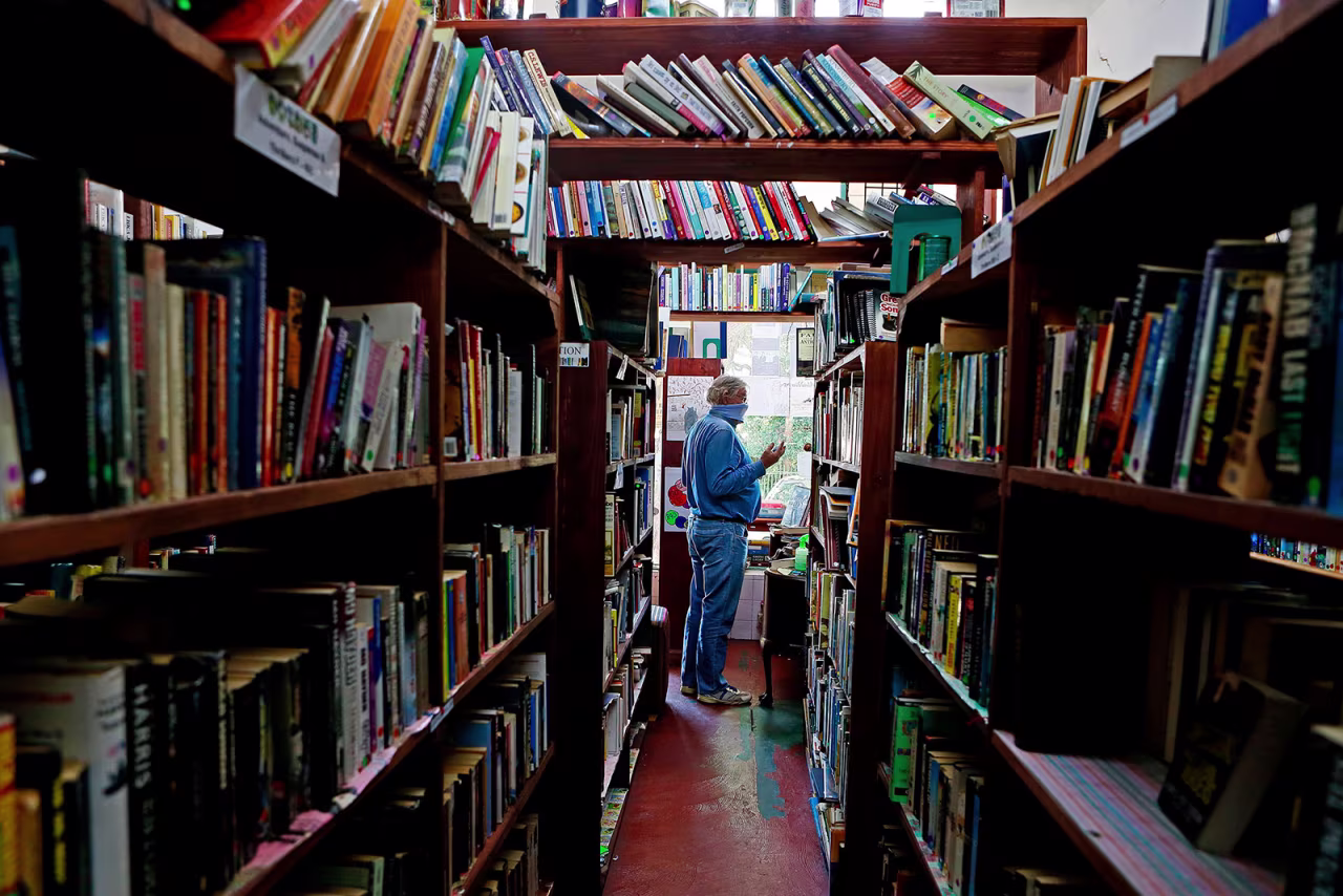 A customer buys a book at Magic Tree Books in Pretoria, South Africa, on May 1.