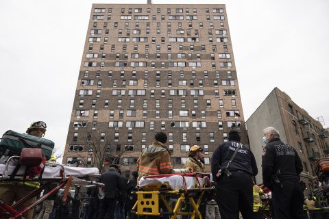 Emergency personnel work at the scene of a fatal fire at an apartment building in the Bronx on Sunday. 