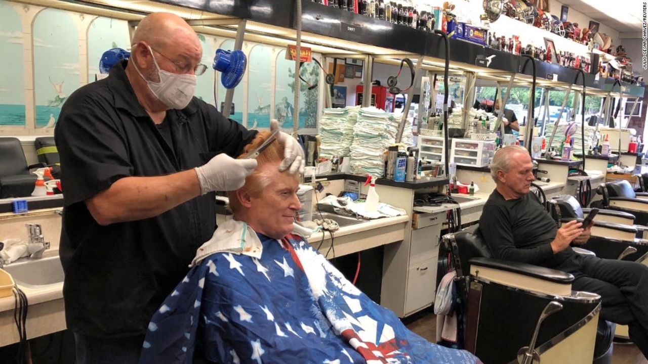 Barber Tommy Thomas gives long-time customer Fred Bentley a haircut after the Georgia governor allowed select businesses to open in Atlanta on April 24.