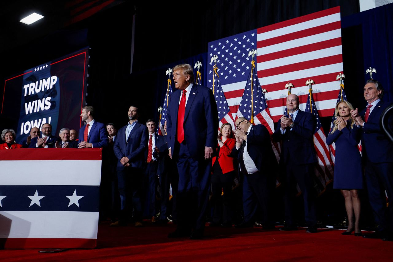 Former President Donald Trump reacts as people applaud during his Iowa caucus night watch party in Des Moines on Monday.