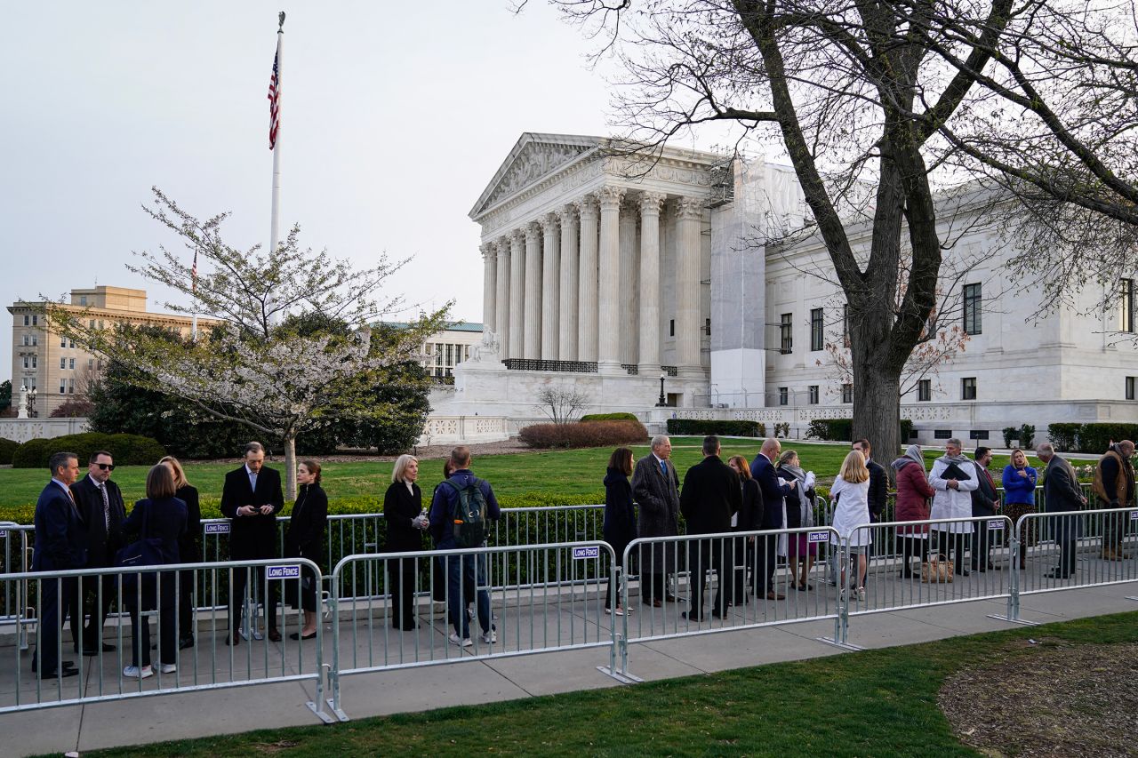 People wait in line outside US Supreme Court to hear oral arguments on March 26, in Washington, DC.