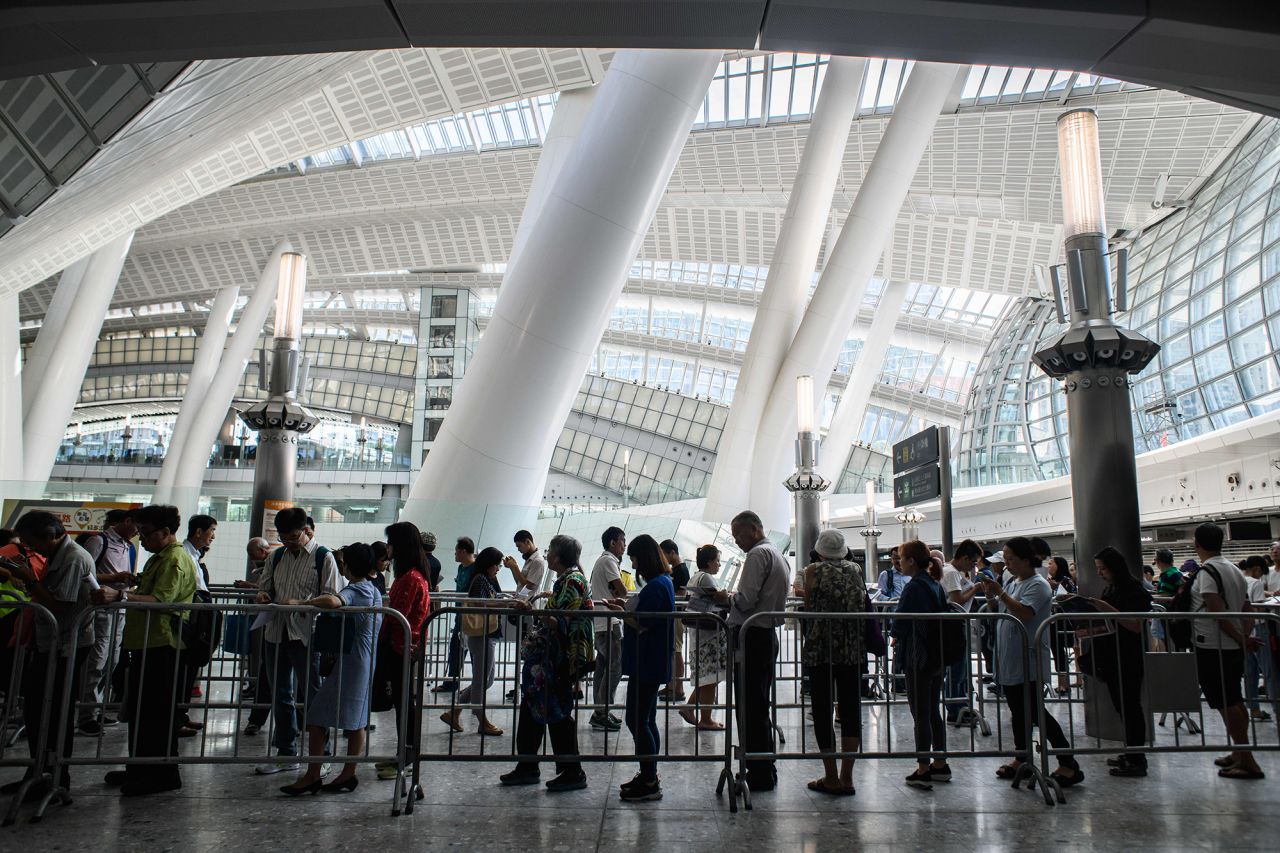 Customers queue to purchase tickets on September 10, 2018. 