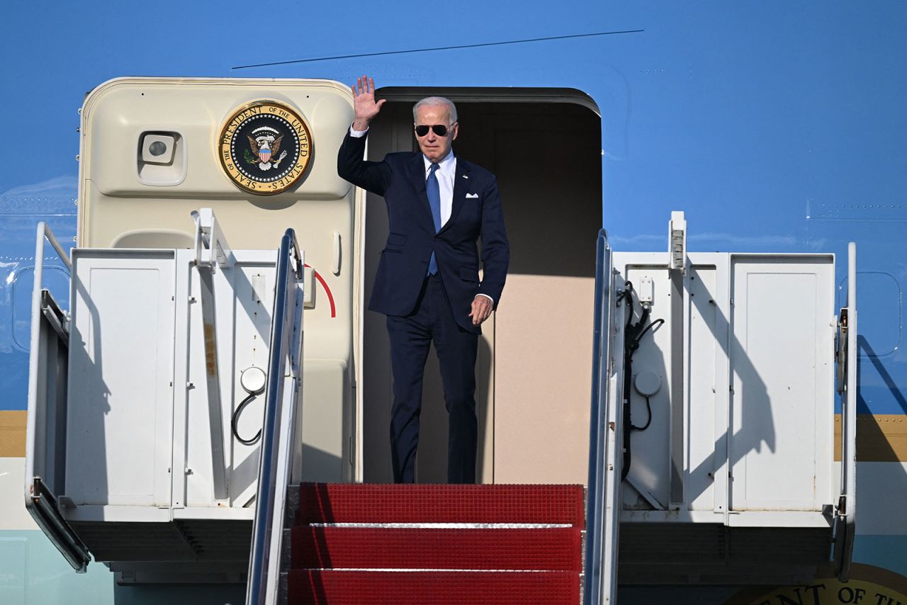 US President Joe Biden waves as he disembarks from Air Force One, upon his arrial at Vilnius International Airport in Lithuania on July 10, 2023 for the NATO summit. 