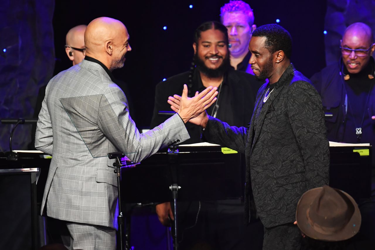 Chair of the Board of Trustees of the Recording Academy Harvey Mason Jr. presents the President's Merit Award to honoree Sean "Diddy" Combs onstage during a pre-Grammy event Sunday in Beverly Hills.