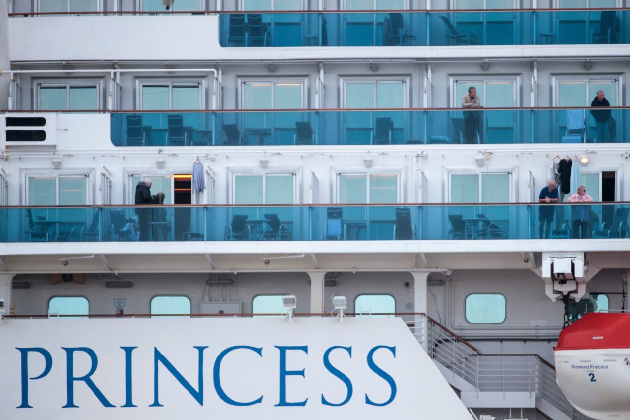 Passengers wearing face masks on the Diamond Princess cruise ship, docked in Yokohama, Japan on February 12, 2020.