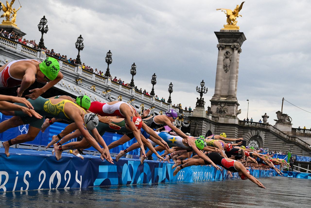 Athletes compete in the swimming race in the Seine during the women's individual triathlon at the Paris 2024 Olympic Games in central Paris on July 31.