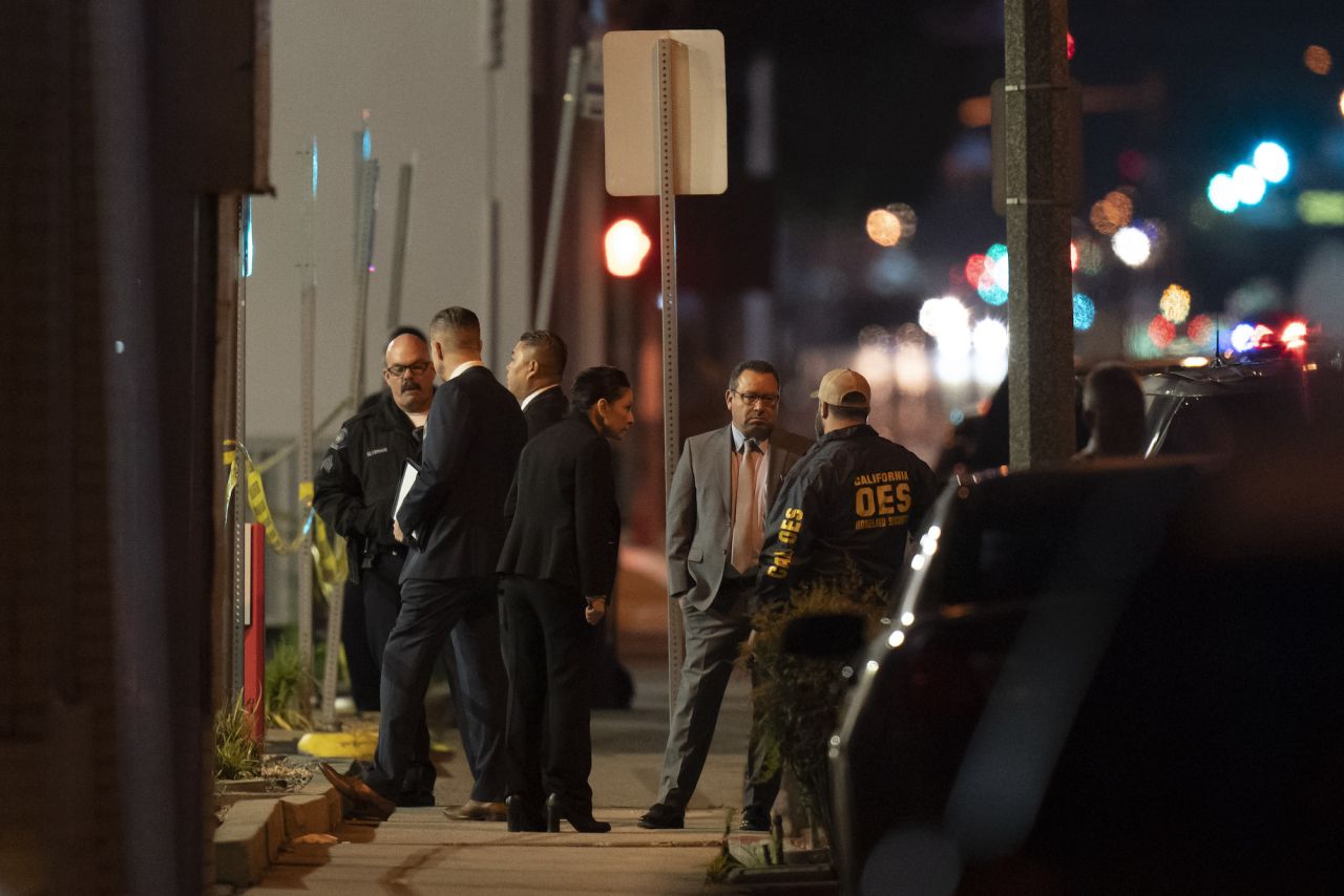 Investigators gather at the scene of the shooting in Monterey Park on Sunday.