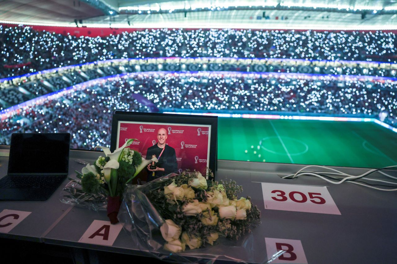 Flowers and a picture of journalist Grant Wahl are seen during the Quarterfinal match between England and France at Al Bayt Stadium in Al Khor, Qatar on Saturday.