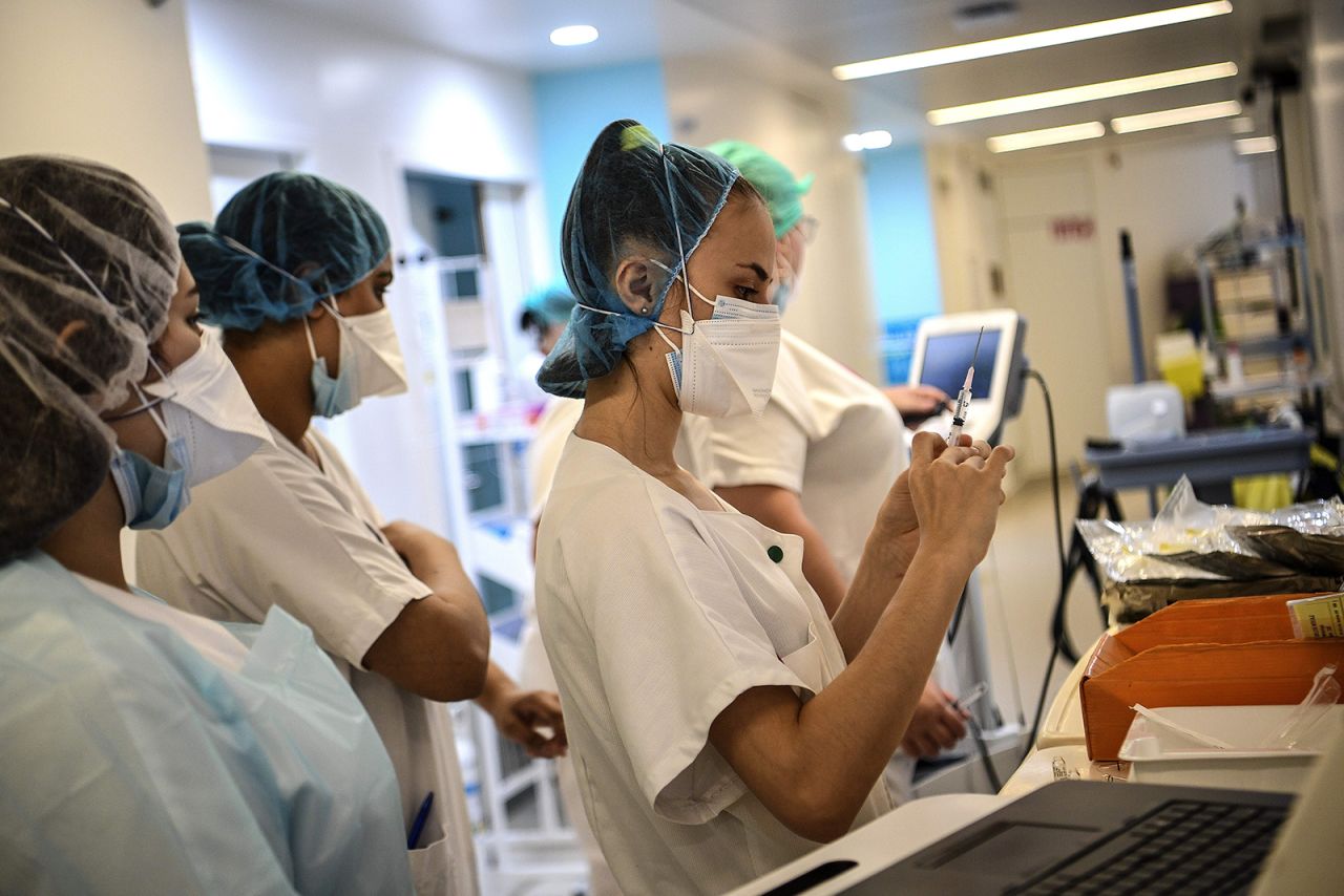 A medical worker prepares an injection in a corridor of the infectious diseases unit of the Gonesse hospital before visiting a patient in Gonesse, north of Paris, on October 22.