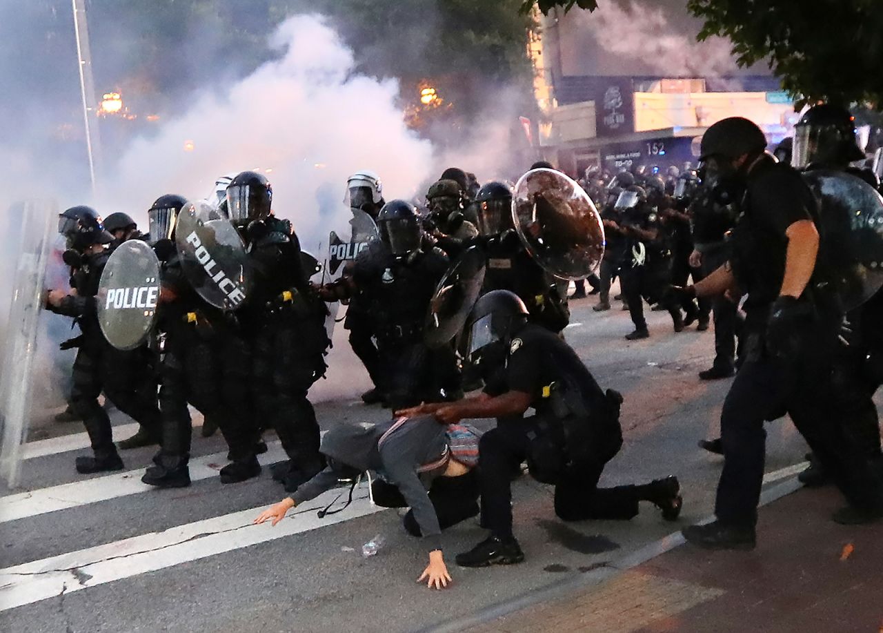 A protester is arrested in Atlanta, on May 31, after throwing tear gas back at police.