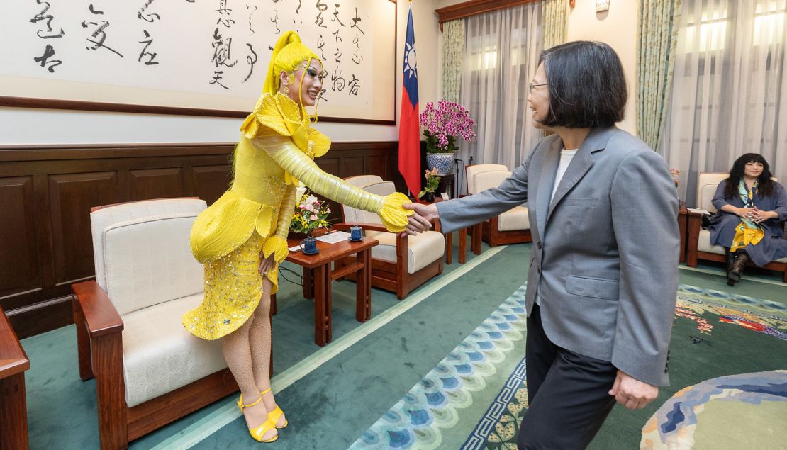 Taiwanese drag queen Nymphia Wind shakes hands with Taiwan's outgoing leader Tsai Ing-wen.