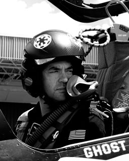 Jared Isaacman is pictured in the cockpit of a jet.