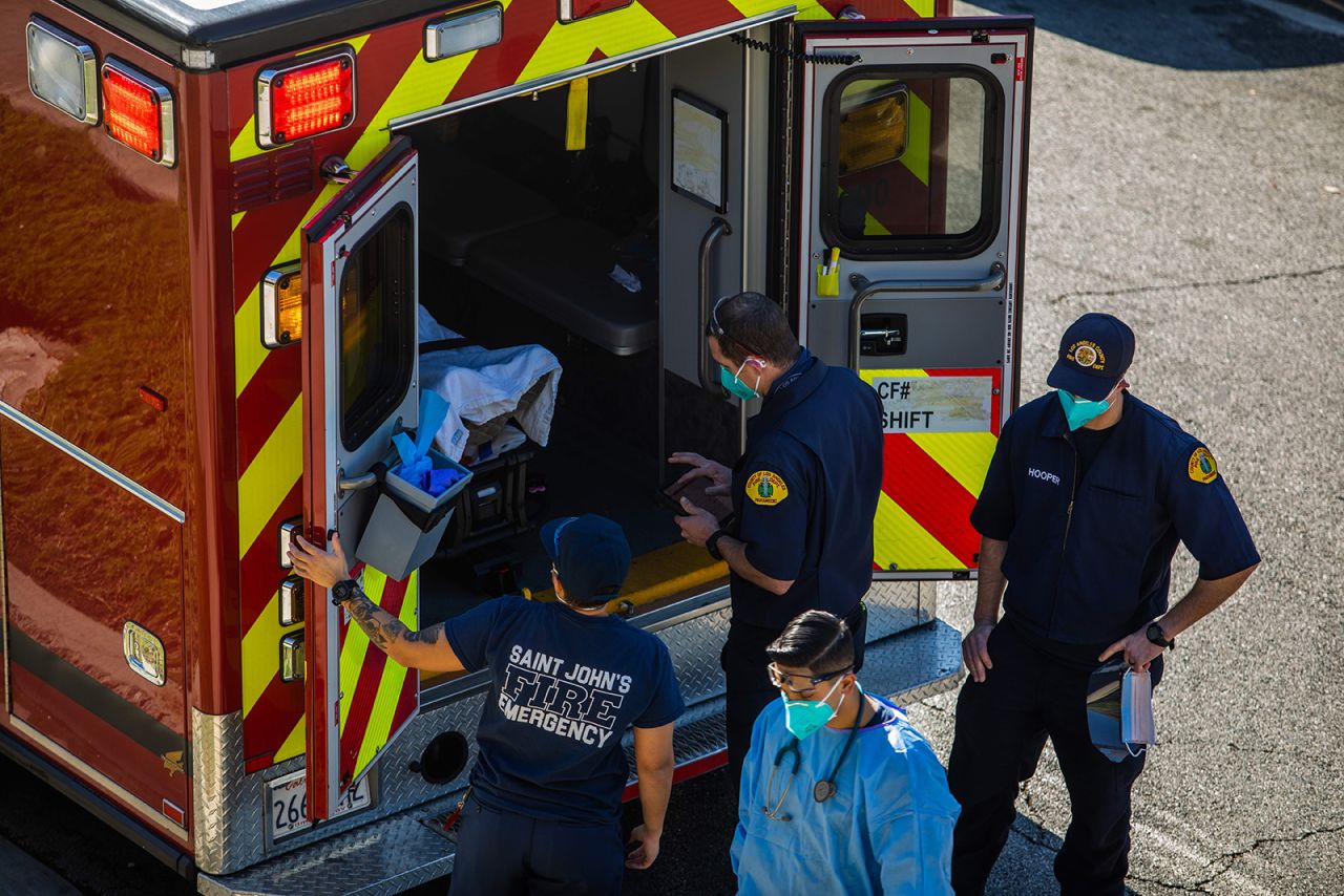 After administering oxygen, County of Los Angeles paramedics load a potential Covid-19 patient in the ambulance before transporting him to a hospital in Hawthorne, California on December 29, 2020.