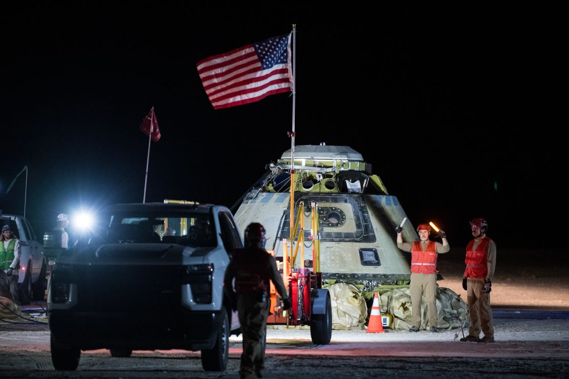 Boeing and NASA teams work around NASA's Boeing Crew Flight Test Starliner spacecraft after it landed uncrewed at White Sands, New Mexico, on September 7.