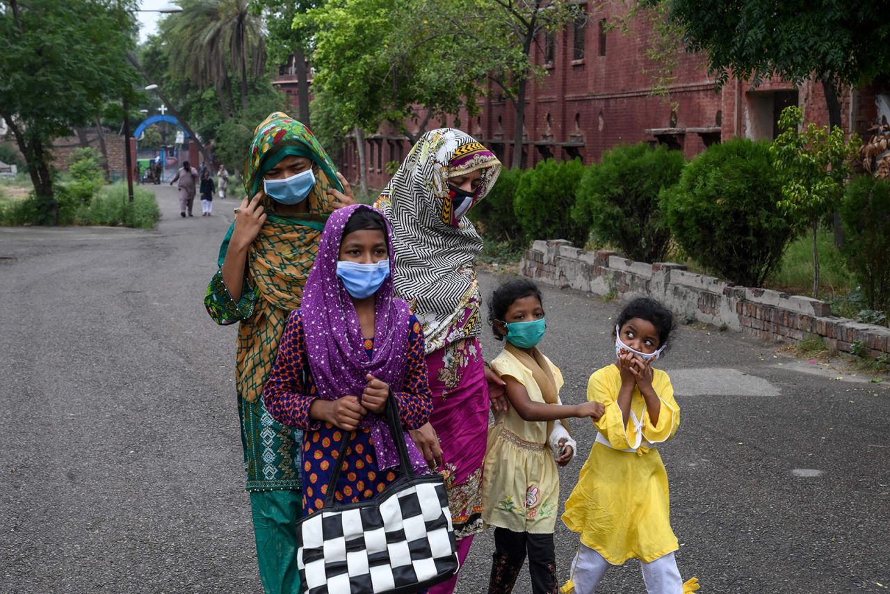 A Catholic family wearing face masks arrives to attend Sunday prayers at the Mary Immaculate Church in Lahore, Pakistan on June 7.