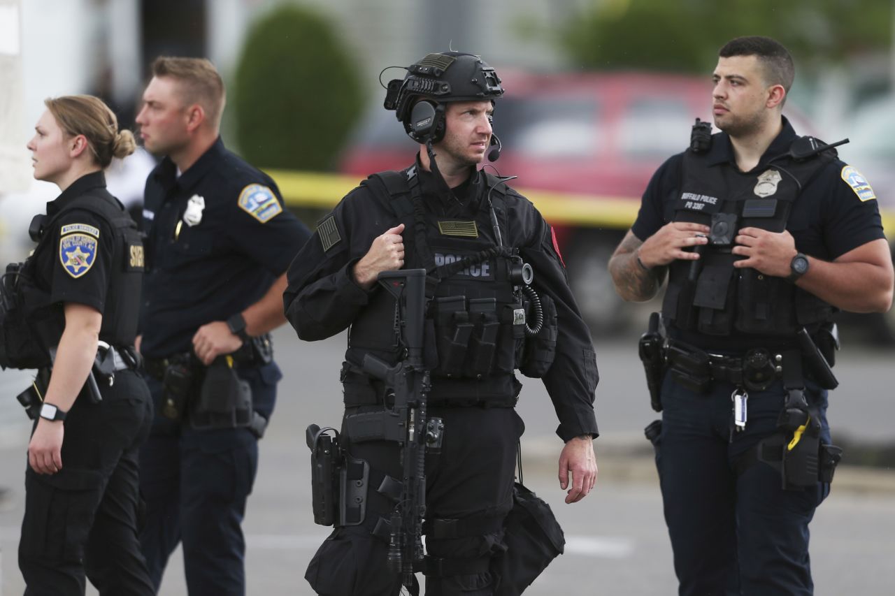 Police investigate the scene after a mass shooting at a Buffalo supermarket. According to the Buffalo Police Department, an alleged shooter is in custody.