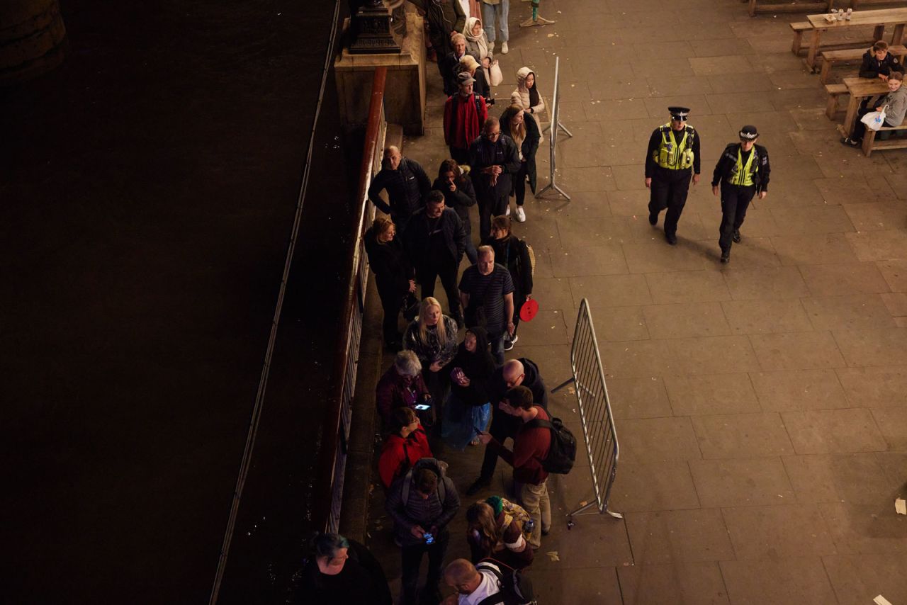 A queue of people waiting to see Queen Elizabeth II lying in state, moves along the South Bank in London on Sunday.