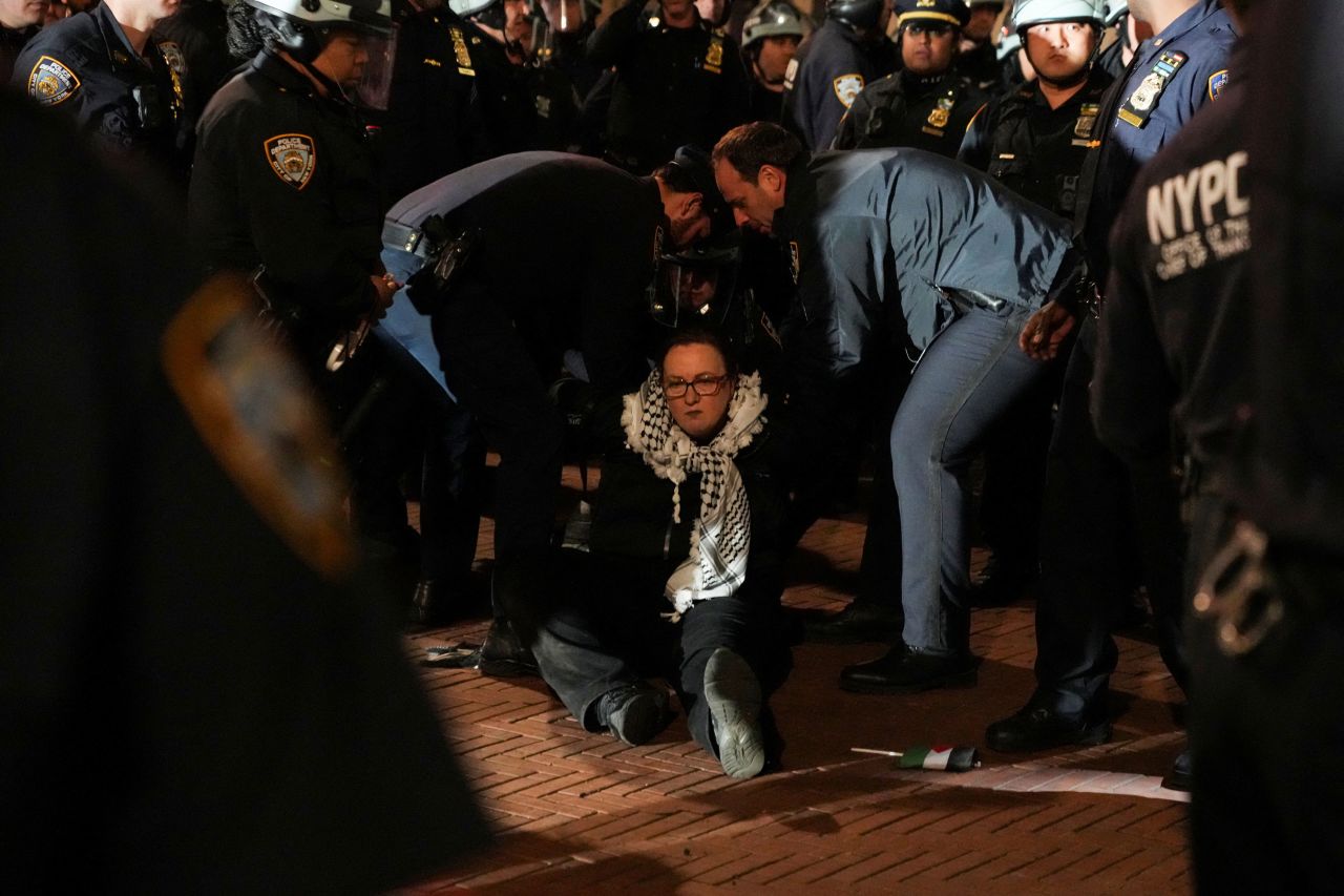 Police detain a protester.