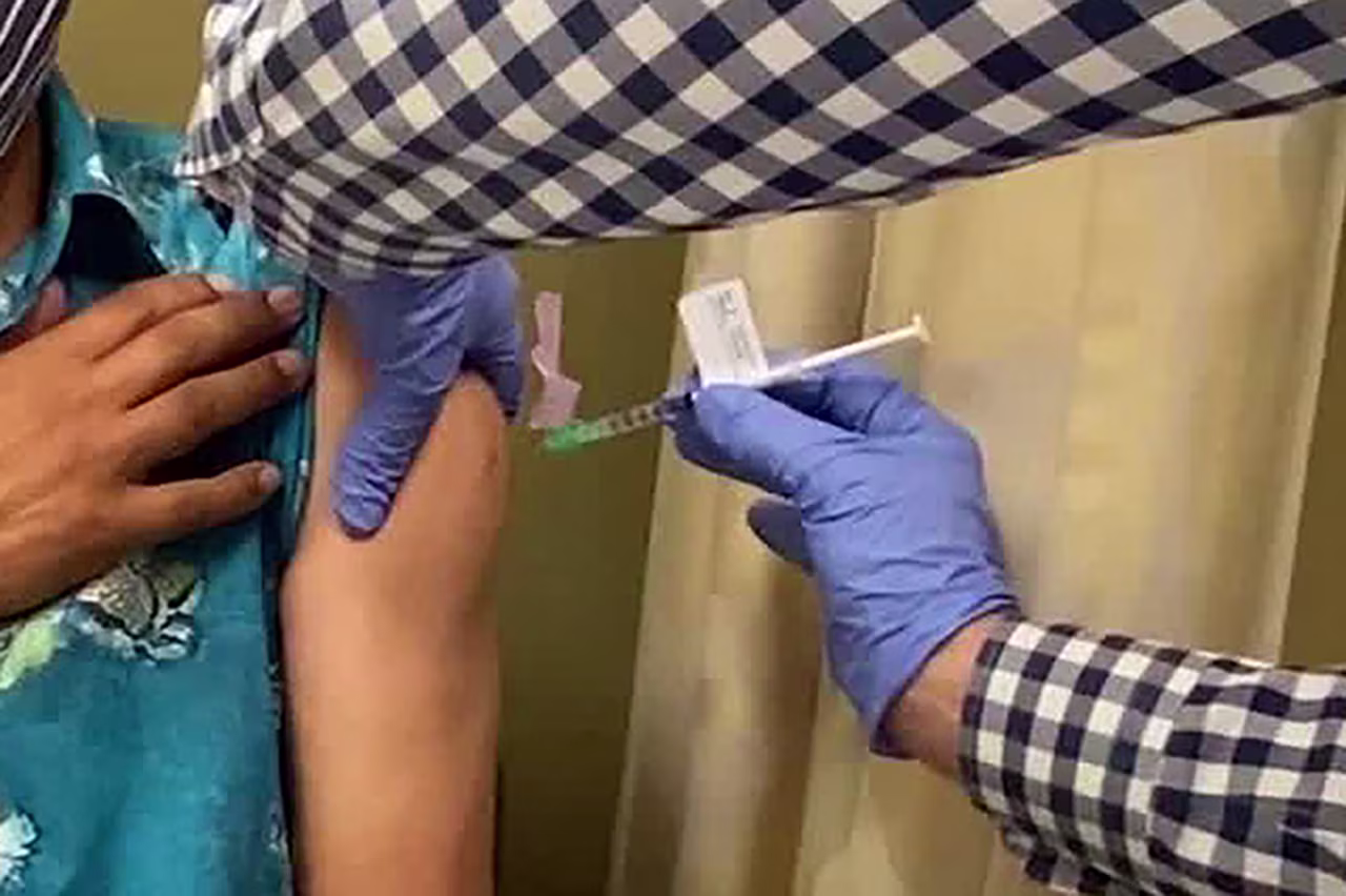 A man receives an injection as UCLA and AstraZeneca begin phase three trials in a potential COVID-19 vaccine. 