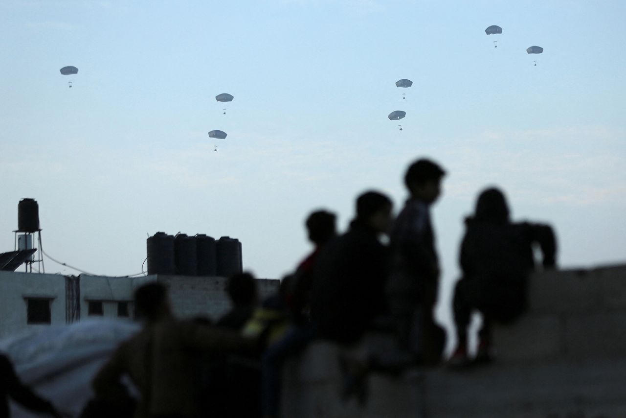 People watch as the US military carries out its first aid drop over Gaza City, on March 2. 