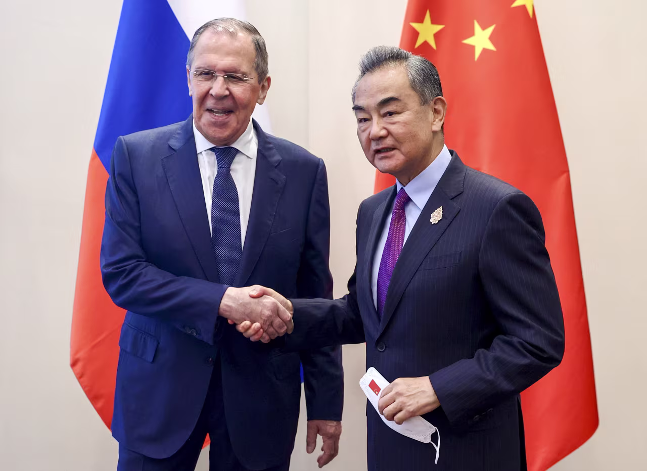 Russian Foreign Minister Sergey Lavrov, left, shakes hands with Chinese Foreign Minister Wang Yi during their bilateral meeting ahead of the G20 Foreign Ministers' Meeting in Nusa Dua, Bali, Indonesia, on July 7.