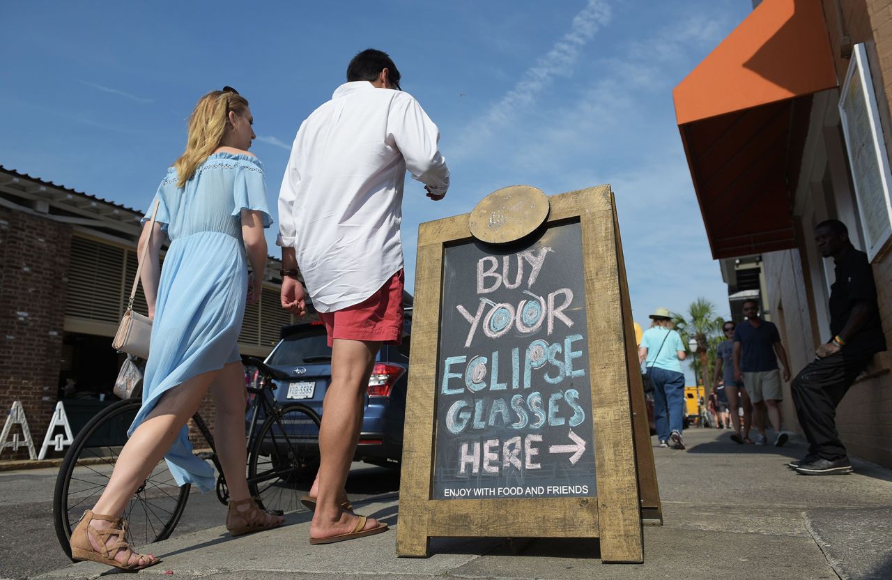 A board advertises eclipse glasses for sale at before the total solar eclipse in Charleston, South Carolina, on August 20, 2017. 