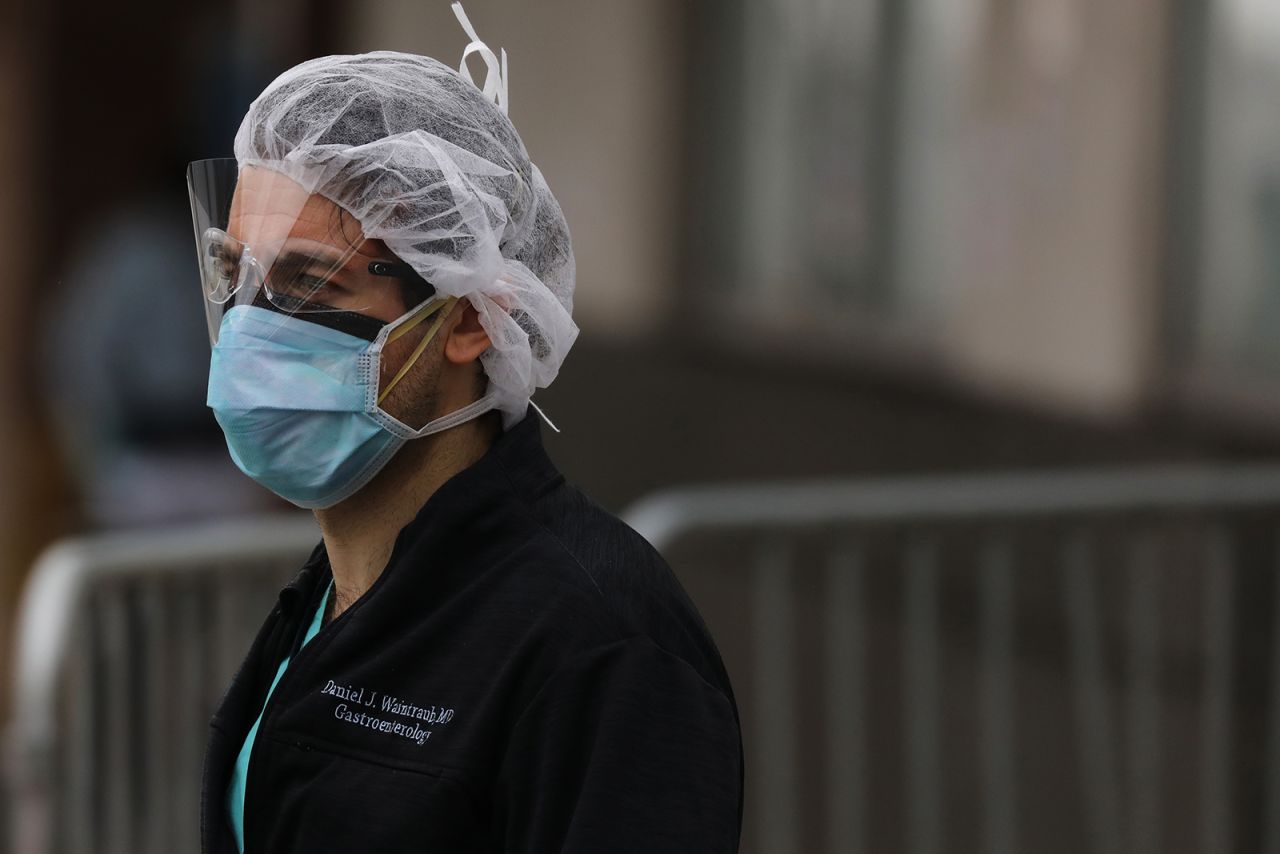 A medical worker stands outside of a special coronavirus intake area at Maimonides Medical Center on April 27, in New York City.