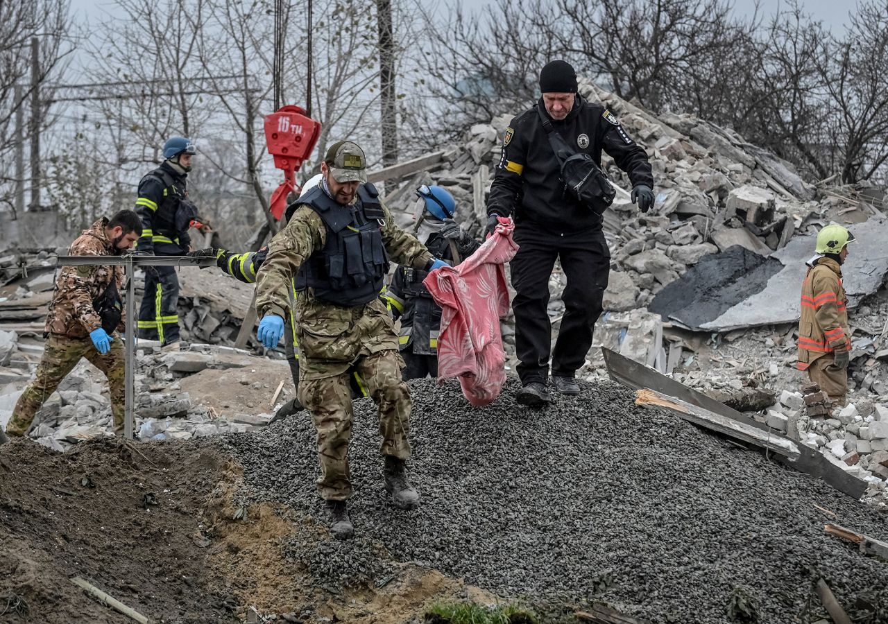 Police officers carry fragments of a body found under debris of a residential house destroyed by a Russian missile strike in the town of Vilniansk,?Zaporizhzhia?region, Ukraine, on November 17.