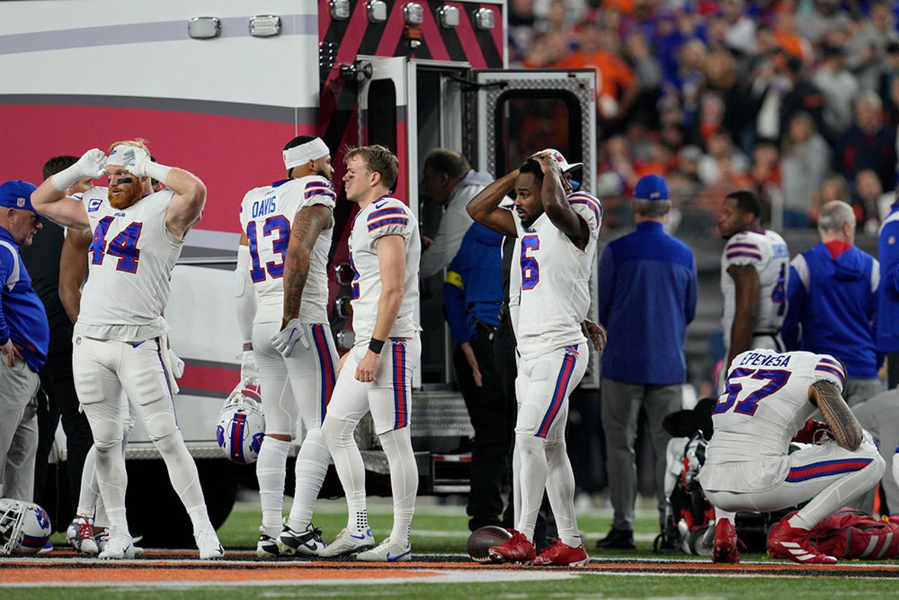 Players react as teammate Damar Hamlin is examined.