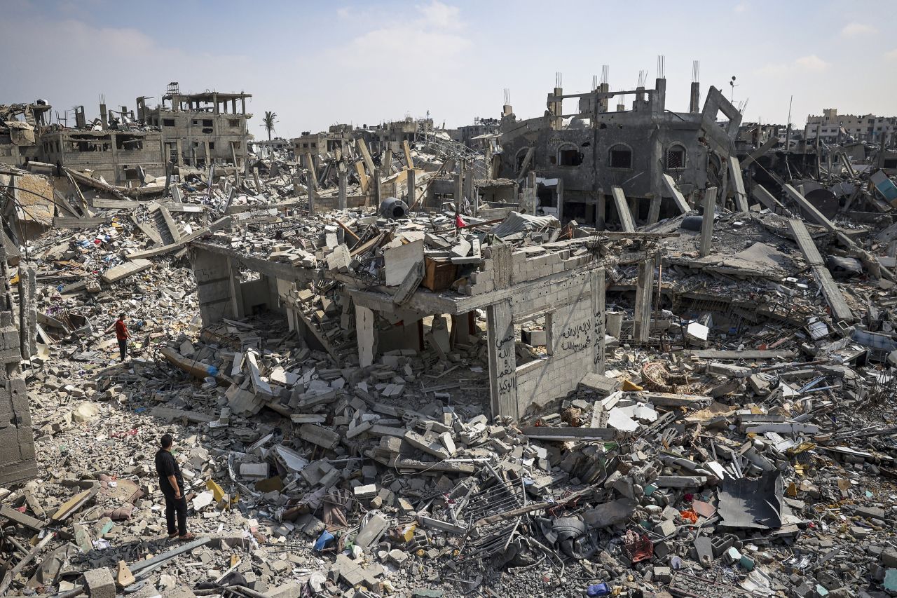 People inspect the damage amid the rubble of buildings destroyed during Israeli bombardment in Khan Younis, Gaza, on April 16.