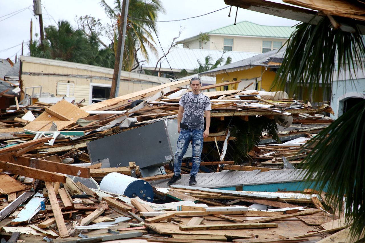 Vince Wright walks through the remains of homes in Fort Myers Beach.