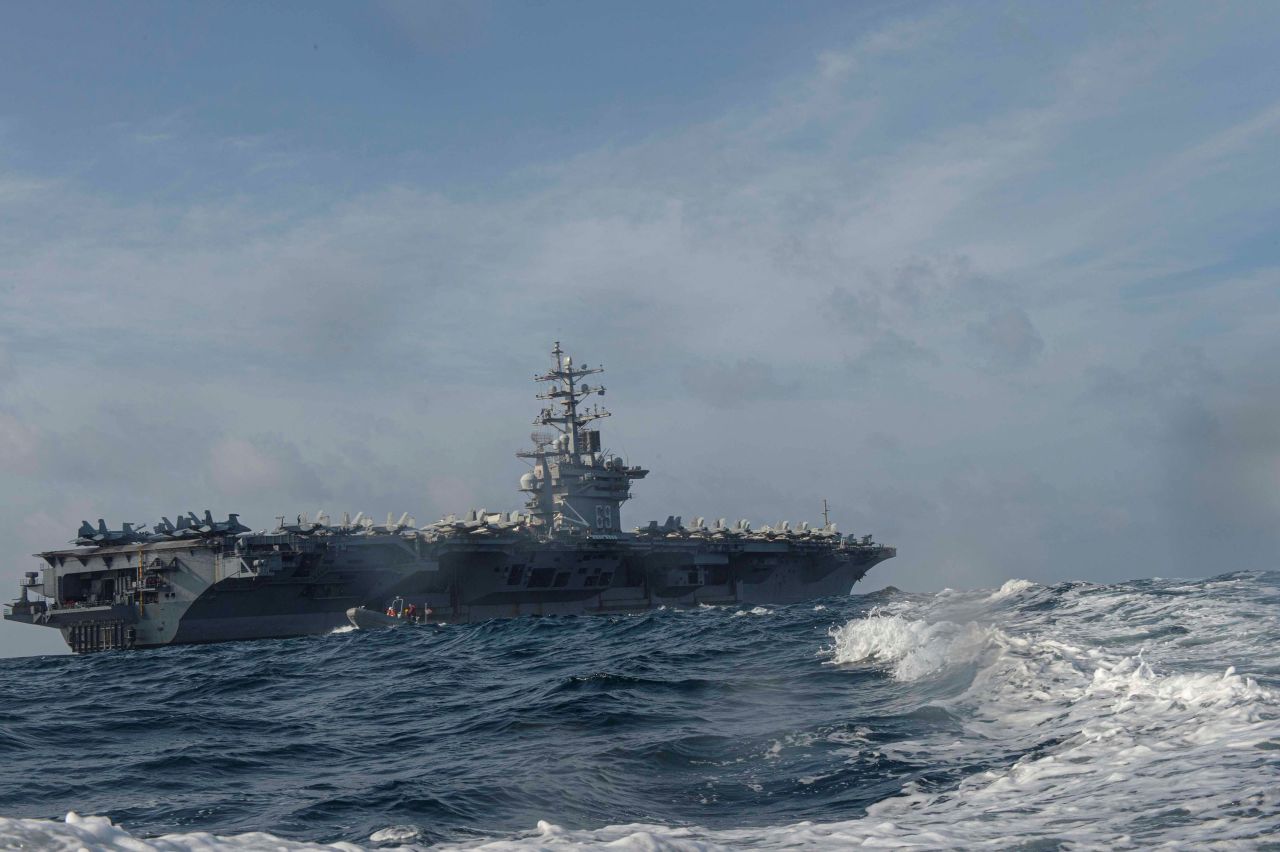 Personnel assigned to the US Navy aircraft carrier USS Dwight D. Eisenhower conduct small boat operations during a training exercise in the Arabian Sea on April 17, 2020. 