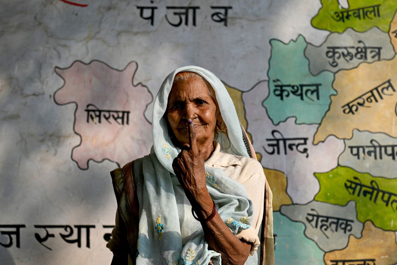 A woman shows her inked finger after casting her vote at a polling station in Tigaon village on the outskirts of Faridabad on May 25, during the sixth phase of voting in India's general elections. 