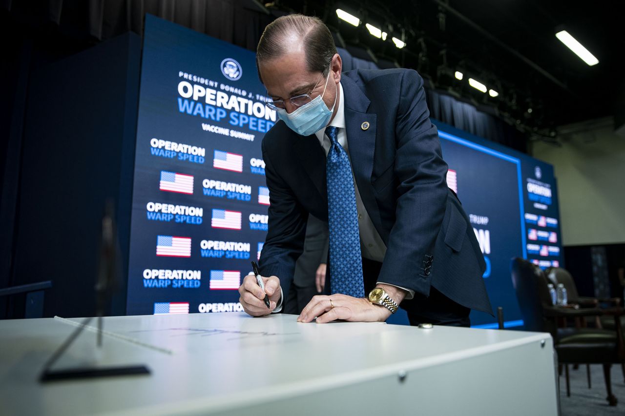 Alex Azar, secretary of Health and Human Services (HHS), signs a Thermo Fisher Scientific Inc. -80C Benchtop Freezer during an Operation Warp Speed vaccine summit at the White House in Washington, D.C., on Tuesday, December 8. 