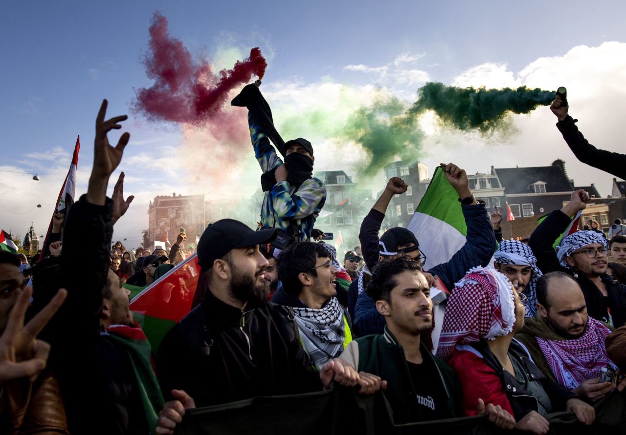 Protesters wave flags during a rally in support of Palestinians in Amsterdam on Sunday.