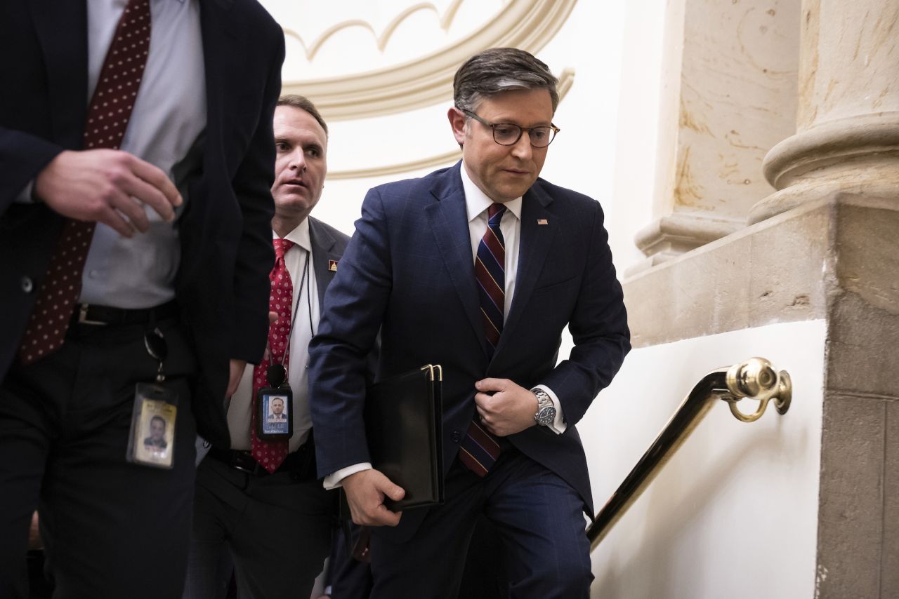 House Speaker Mike Johnson is seen surrounded by reporters and security guards at the Capitol on Tuesday.