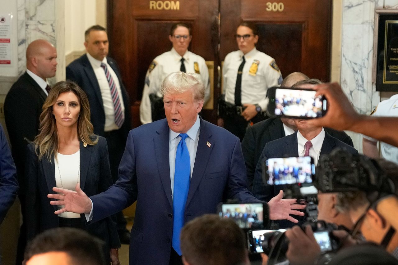 Former President Donald Trump, center, speaks to the media upon arriving at New York Supreme Court, Monday, Oct. 2, 2023, in New York.