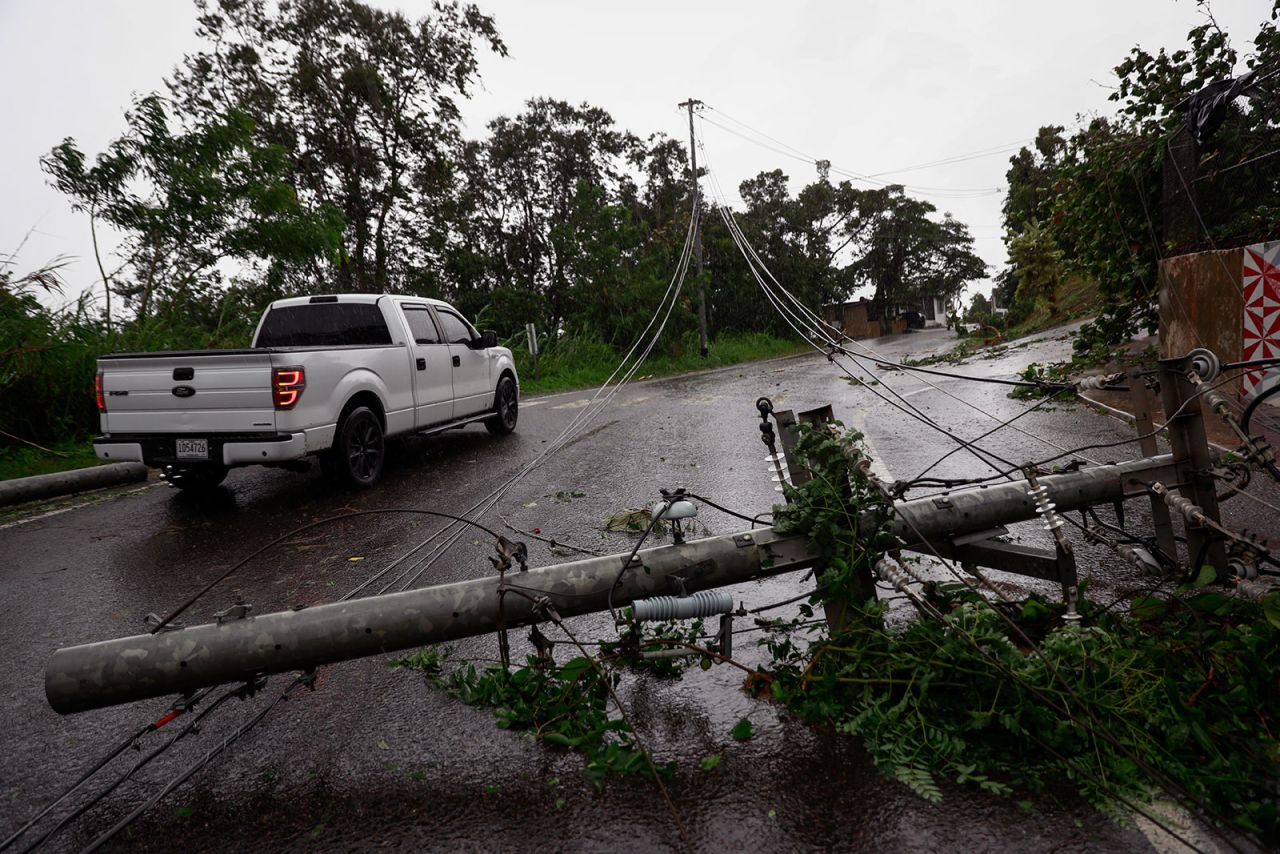 A truck is seen next to downed power lines in Cayey, Puerto Rico as the island awoke to a general power outage on September 19. 