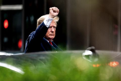 Former President Donald Trump gestures as he departs Trump Tower on Wednesday, August 10.