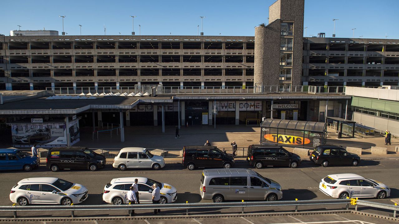 Taxi drivers wait for customers outside Terminal 1 at Manchester Airport in Manchester, UK, on June 1.