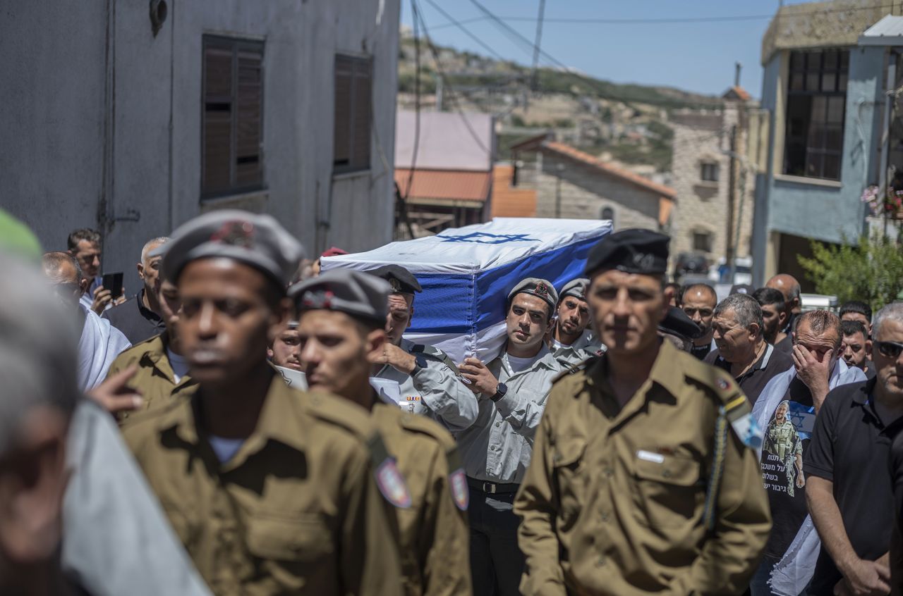 Israeli soldiers carry the flag-draped casket of Israeli soldier Wassem Mahmoud, who was killed when an armoured personnel carrier exploded near the southern Gaza city of Rafah, during his funeral in Beit Jann, Israel, on June 16.