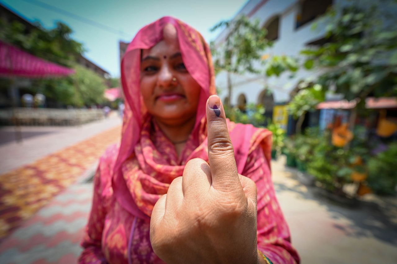 A voter shows her inked finger after casting her vote during the sixth phase of the election at a polling station in New Delhi on May 25.
