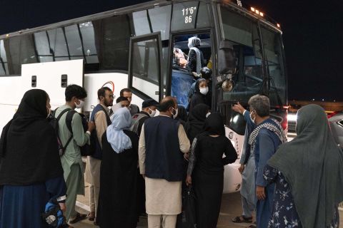 Evacuees from Kabul, Afghanistan board a bus after arriving at Washington Dulles International Airport in Chantilly, Virginia, on Saturday, August 21.